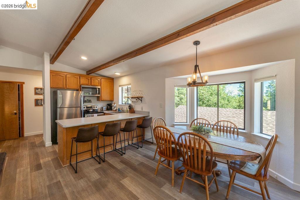 19266 Ferretti Road Groveland, CA 95321 - Photo 6 of 50 Dining space with hanging lights, dark wood-type flooring, and lofted ceiling with beams