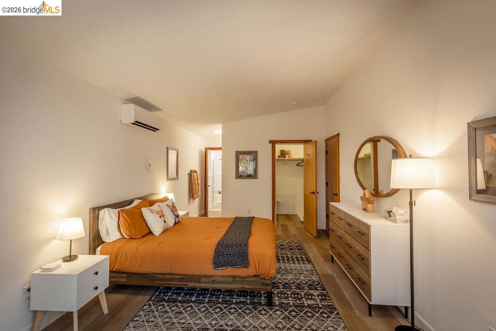 19266 Ferretti Road Groveland, CA 95321 - Photo 9 of 50 Bedroom featuring a walk in closet, wood finished floors, and ensuite bathroom