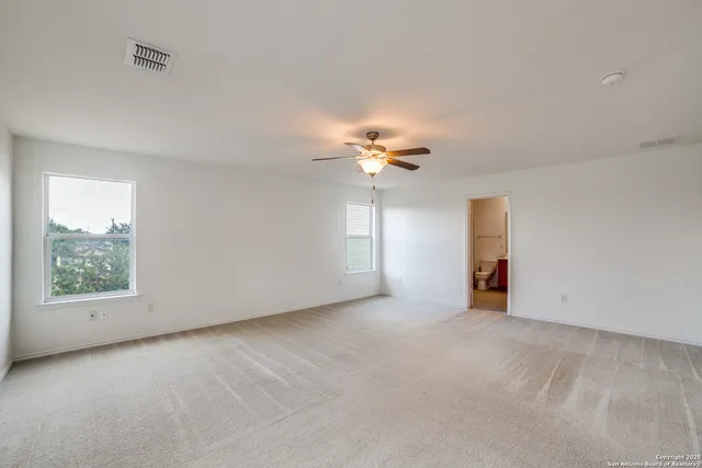 a view of a livingroom with a chandelier fan