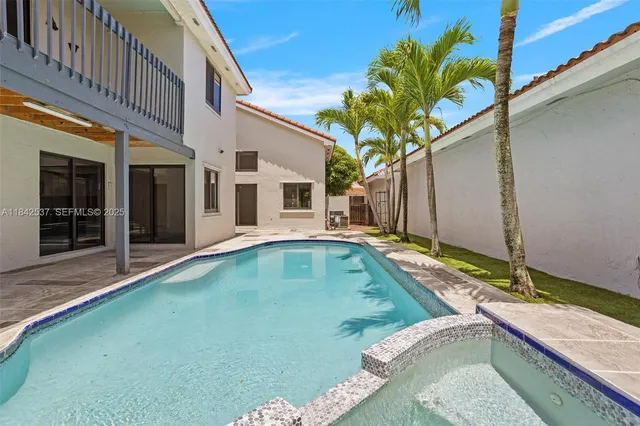 a kitchen with kitchen island a refrigerator sink and stove