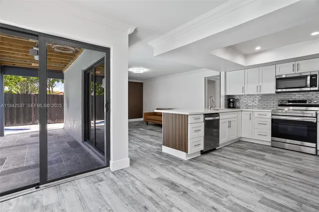 a view of a hallway with washer and dryer