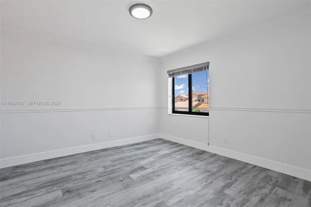 a bathroom with a granite countertop sink mirror and a bathtub