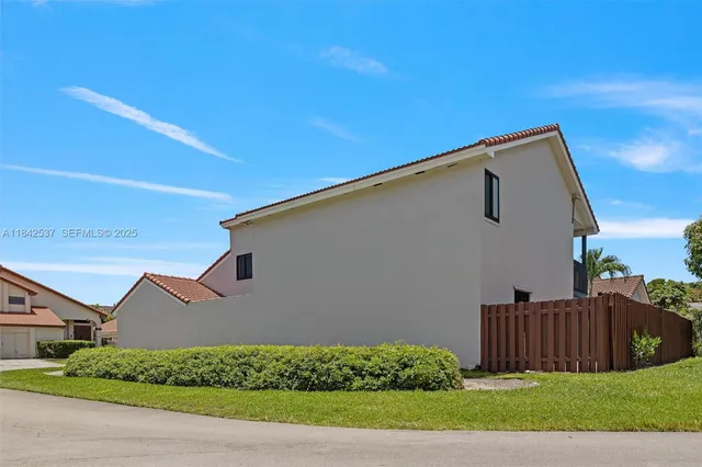 a view of kitchen with sink microwave and cabinets