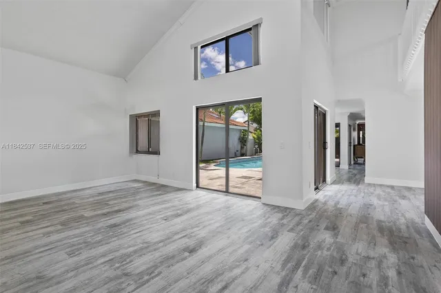 a kitchen with sink and mirror