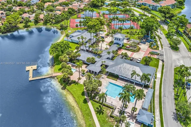 a kitchen with stainless steel appliances a stove top oven a sink and a refrigerator