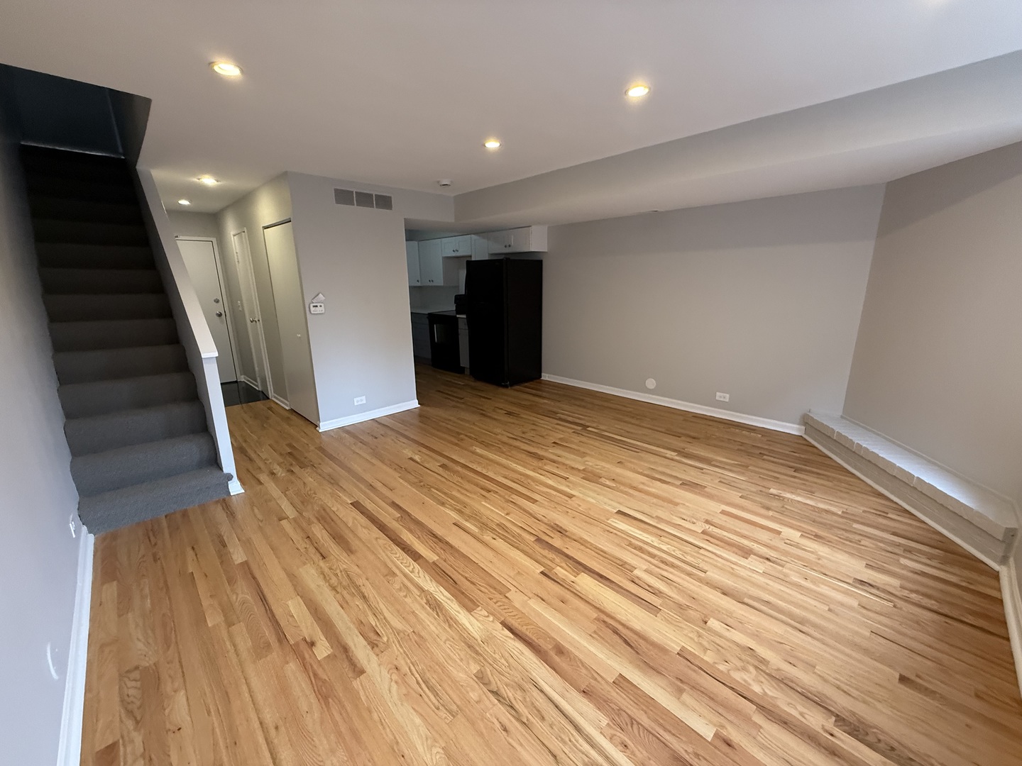 744 West Gordon Terrace, Unit 302 Chicago, IL 60613 - Photo 3 of 12 a view of an empty room with wooden floor