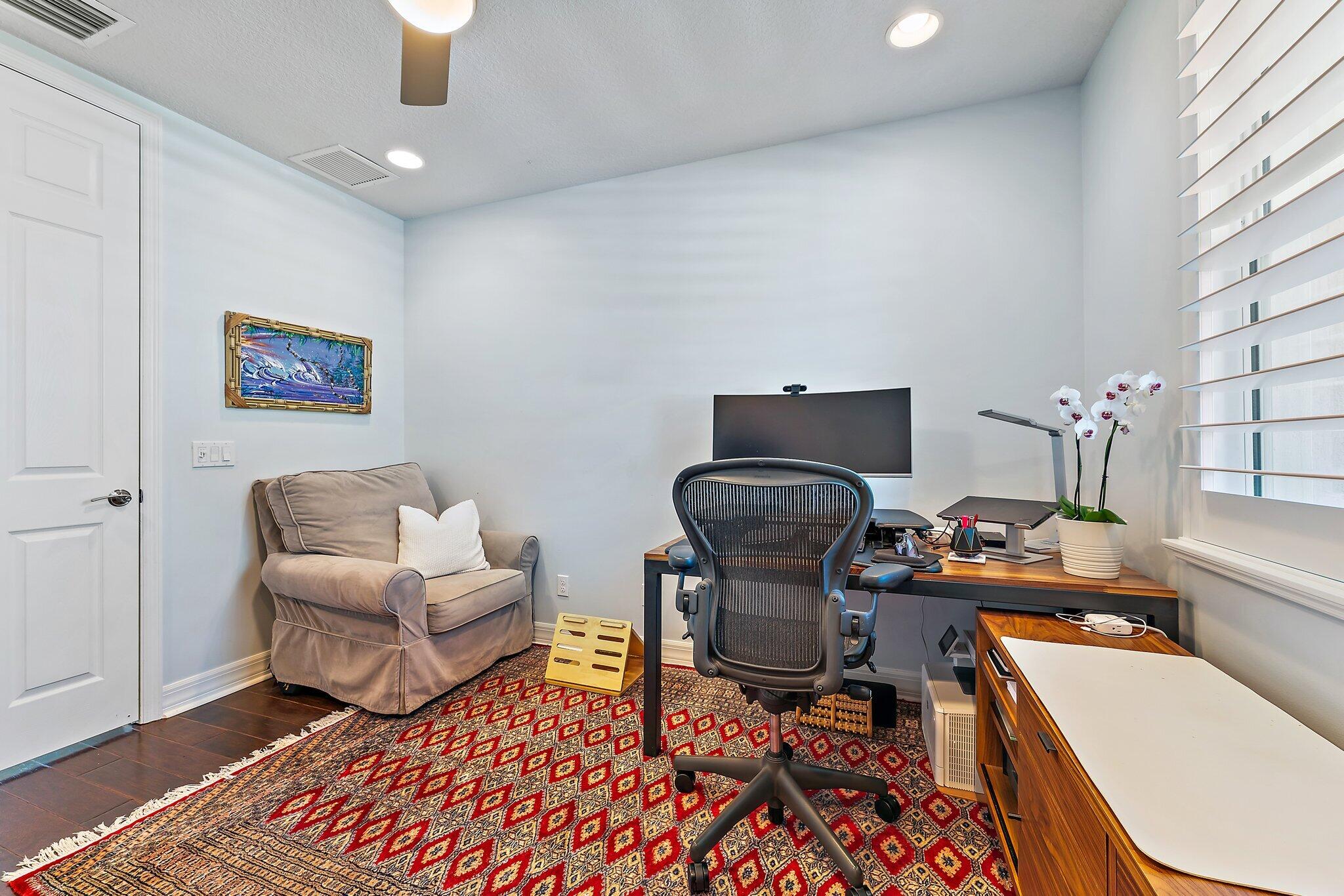 2835 East Mallory Boulevard Jupiter, FL 33458 - Photo 19 of 51 a work room with furniture and a lamp