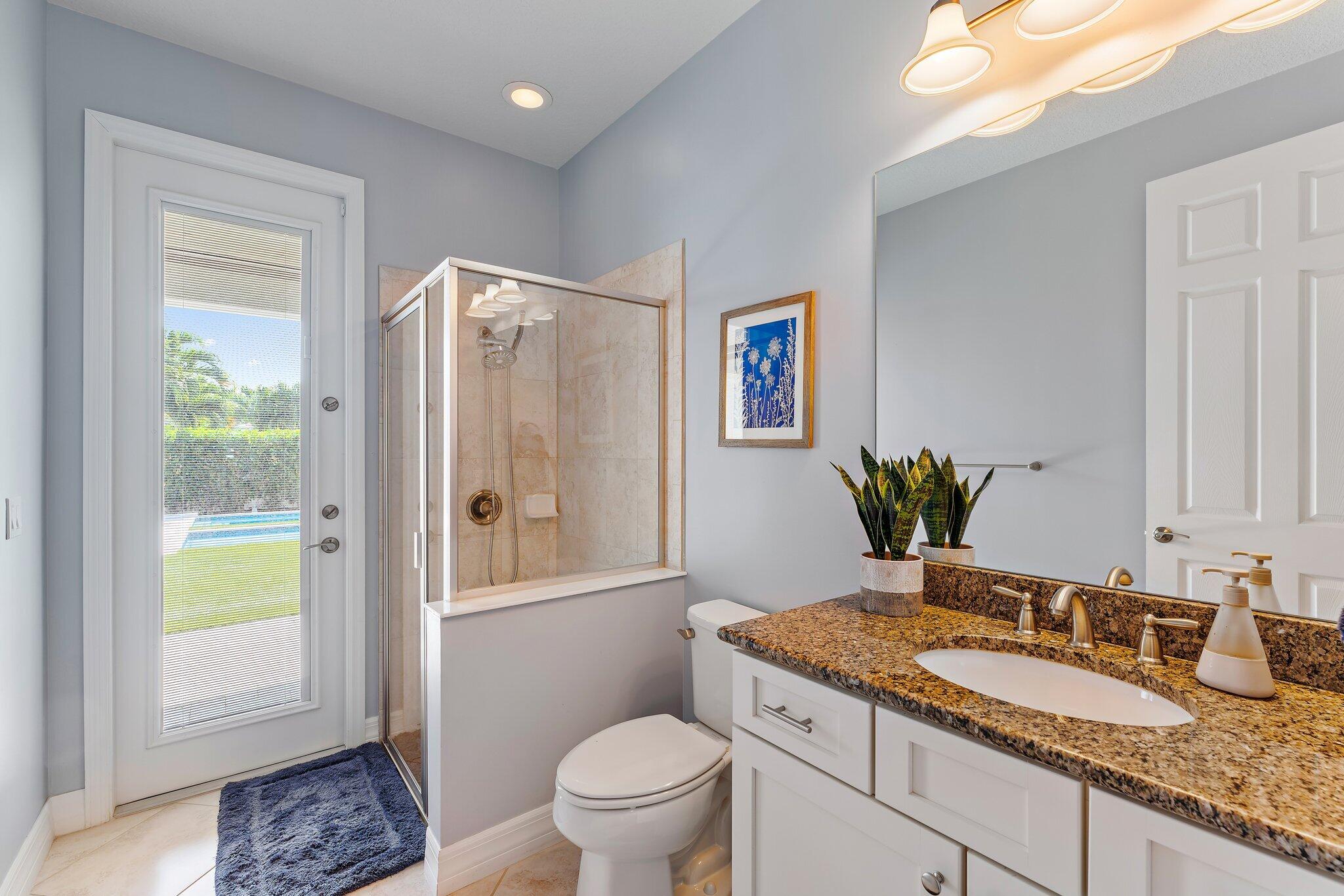 2835 East Mallory Boulevard Jupiter, FL 33458 - Photo 20 of 51 a bathroom with a granite countertop sink toilet and shower