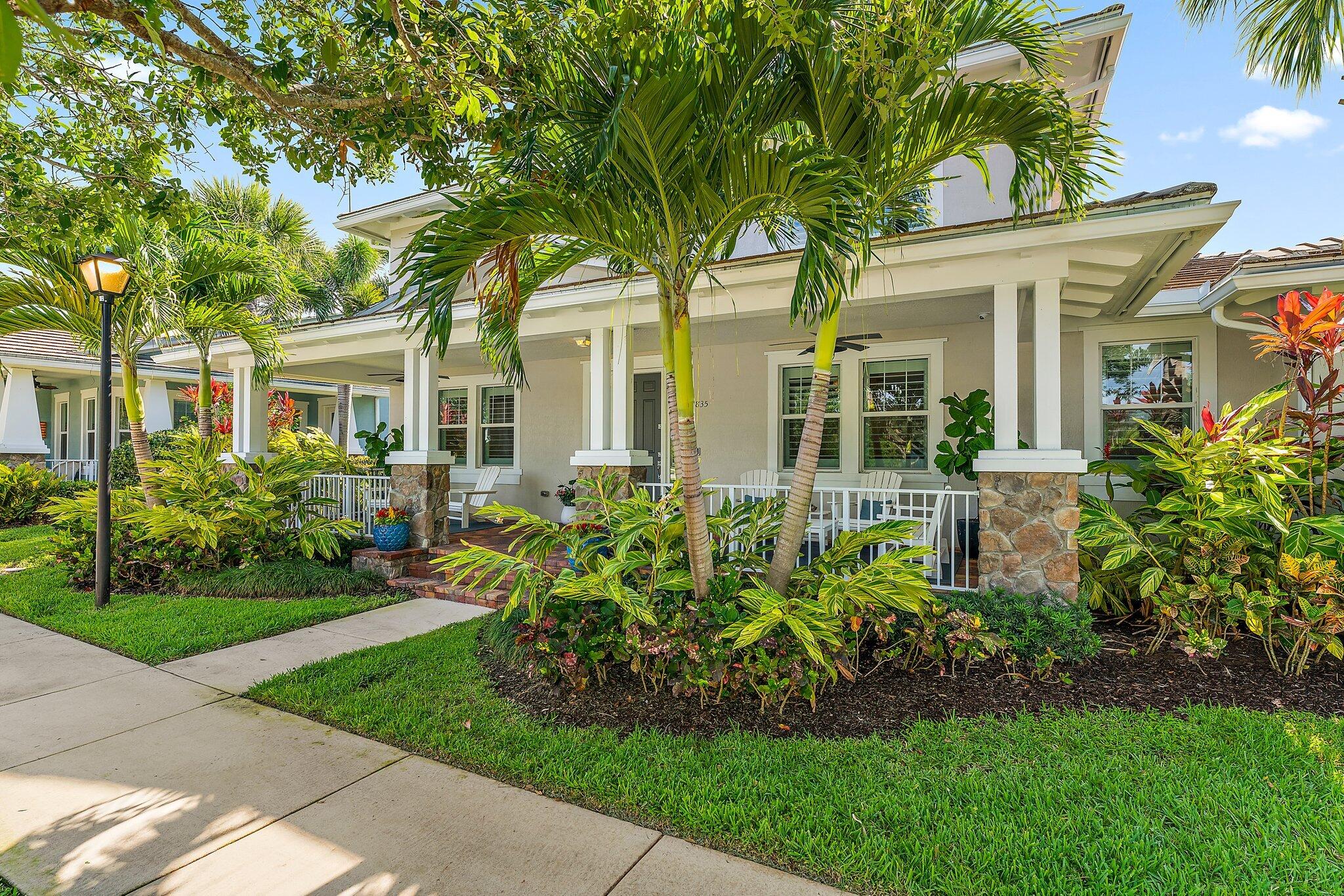 2835 East Mallory Boulevard Jupiter, FL 33458 - Photo 2 of 51 a front view of a house with a garden