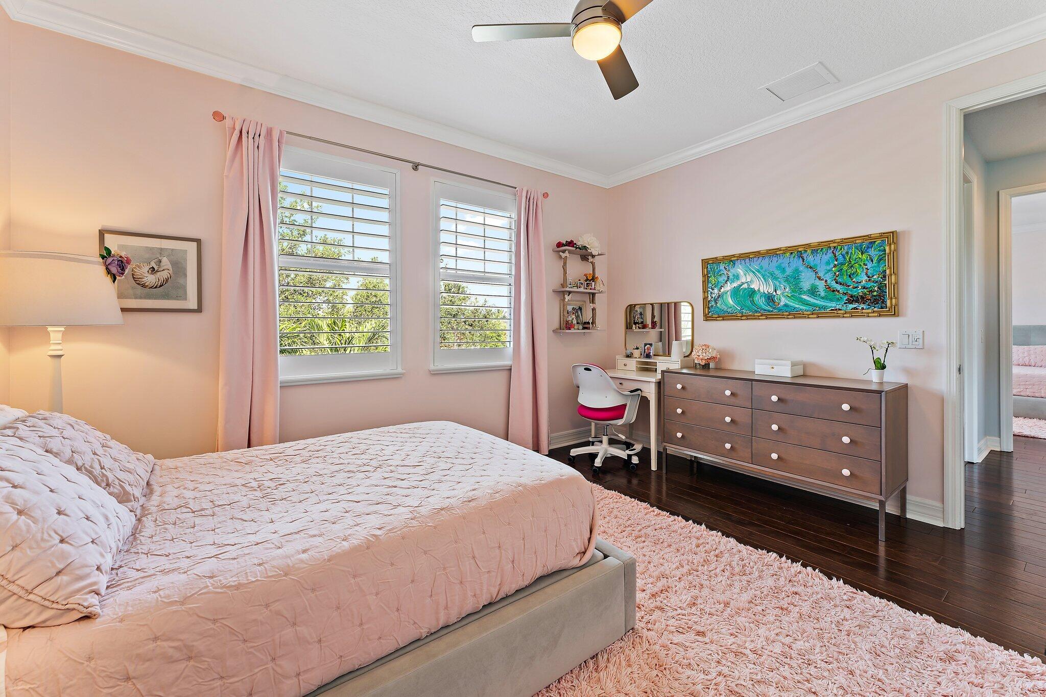 2835 East Mallory Boulevard Jupiter, FL 33458 - Photo 25 of 51 a bedroom with a bed and a flat screen tv