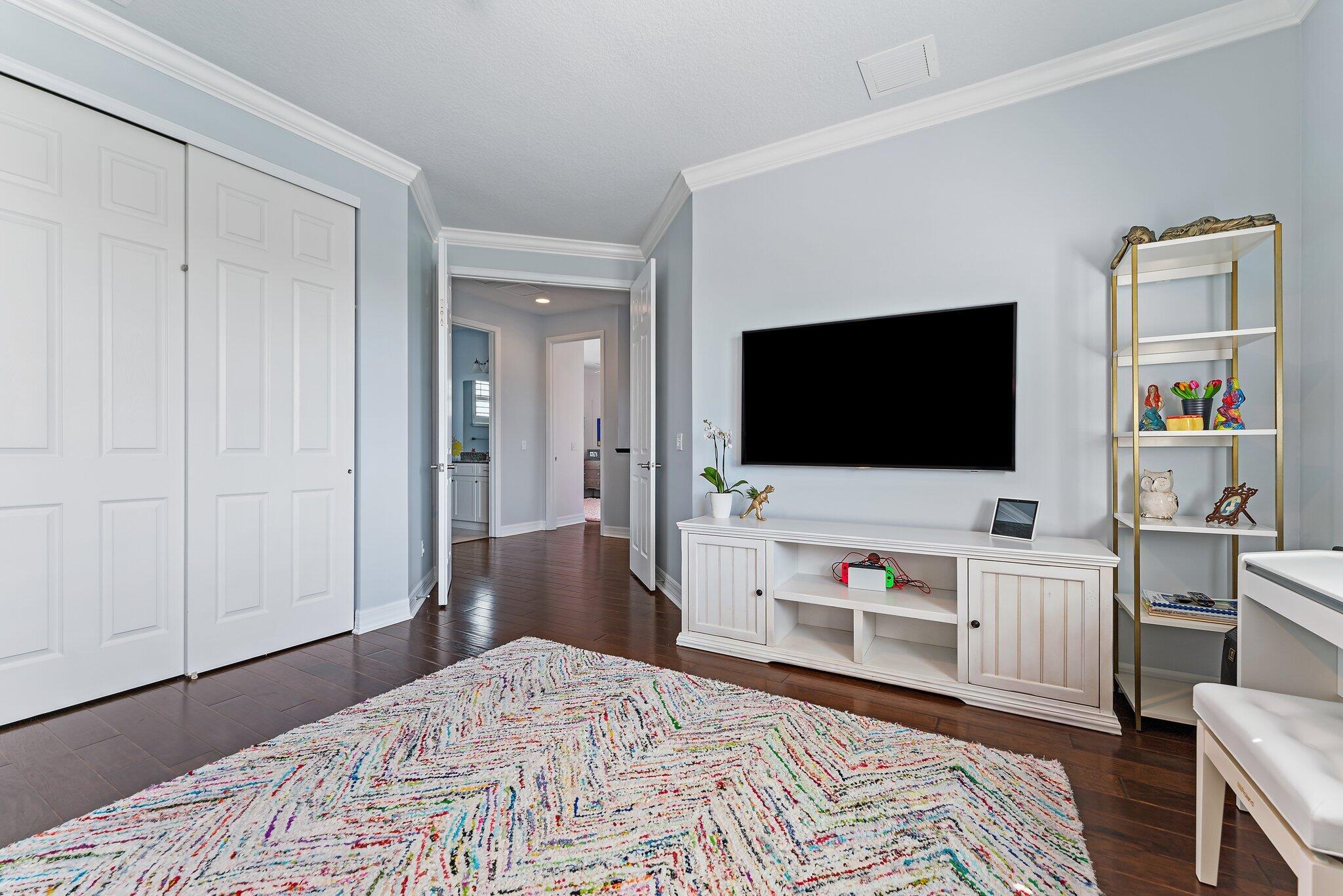 2835 East Mallory Boulevard Jupiter, FL 33458 - Photo 28 of 51 a bedroom with a flat screen tv and a bed