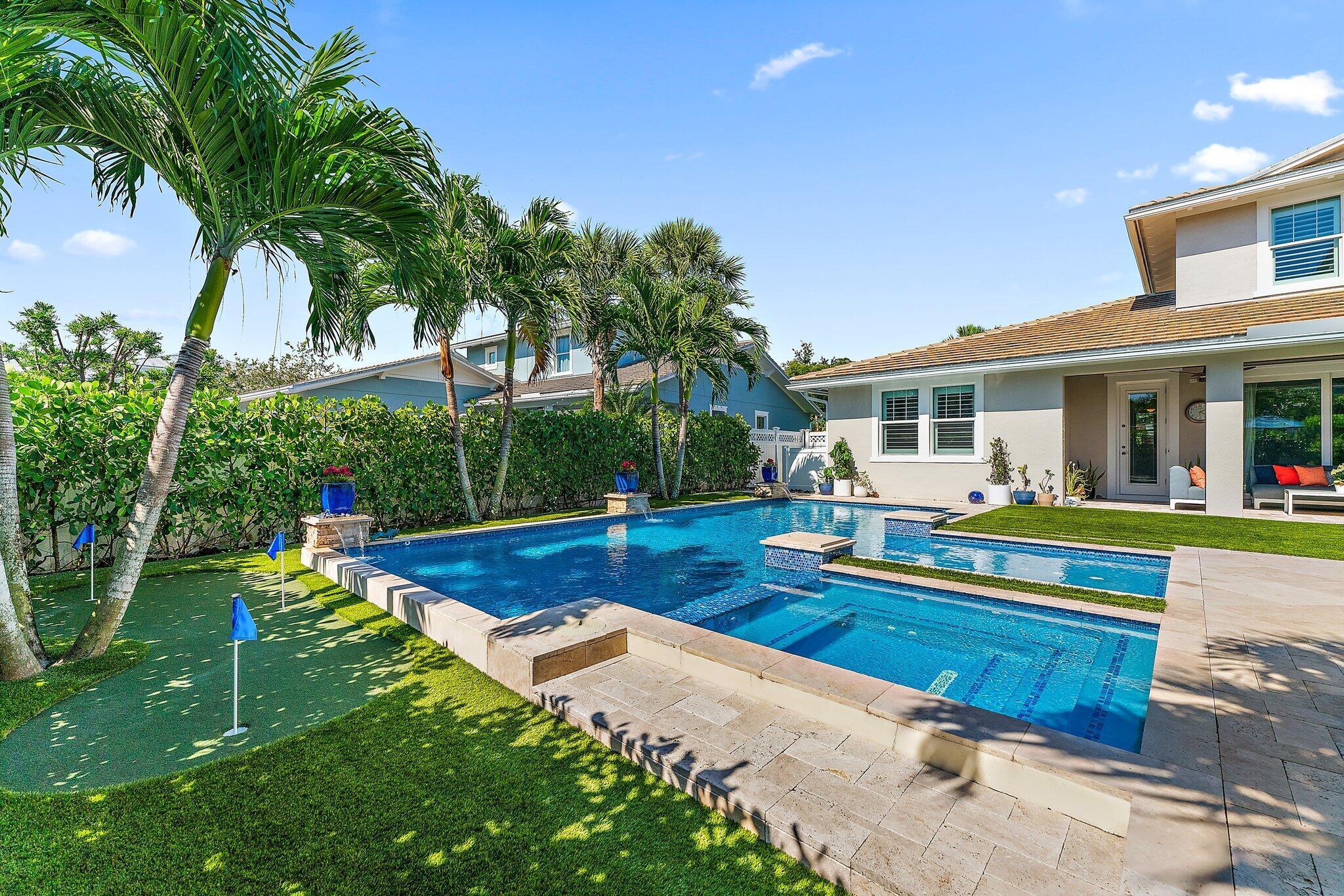 2835 East Mallory Boulevard Jupiter, FL 33458 - Photo 37 of 51 a view of an house with backyard and swimming pool