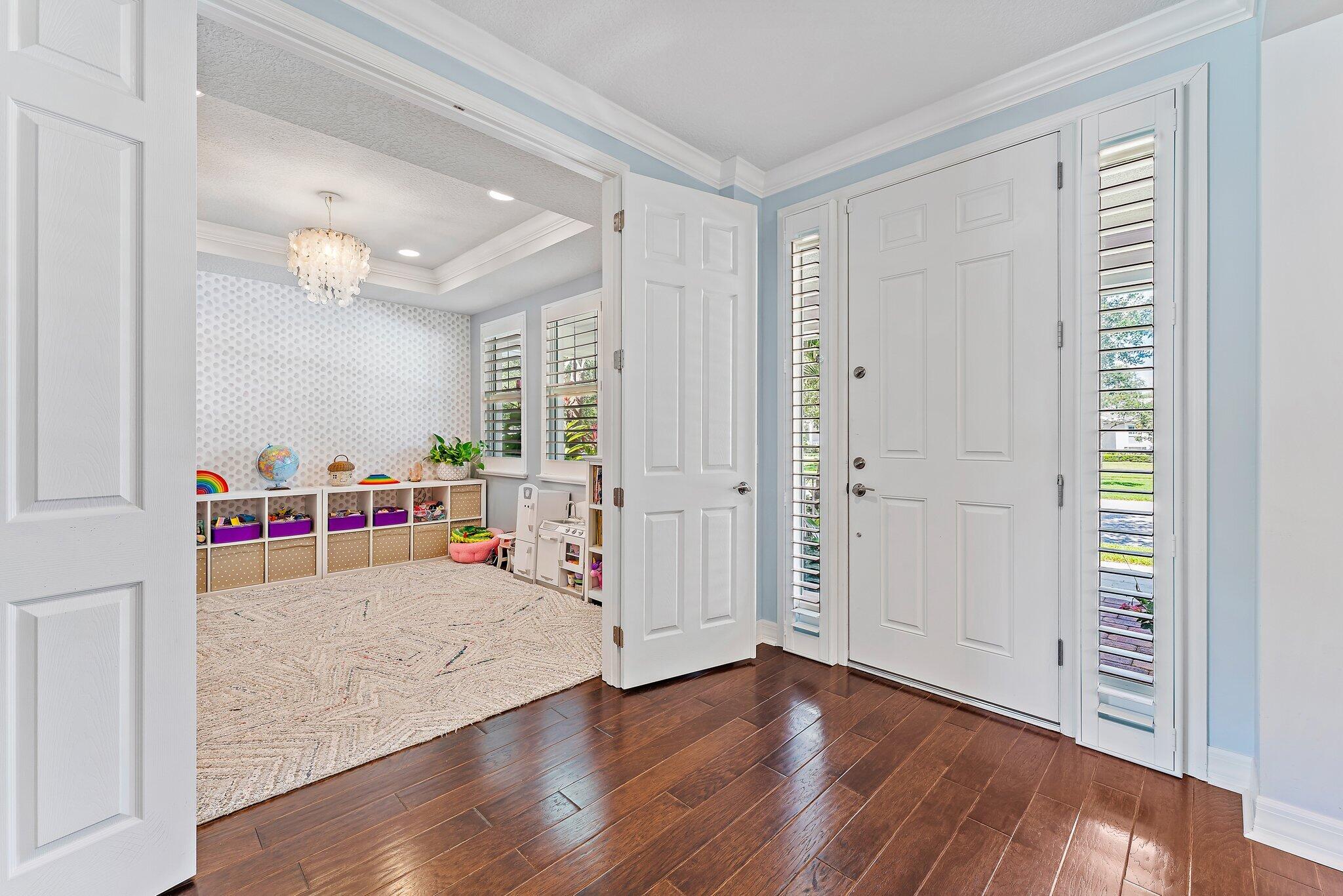 2835 East Mallory Boulevard Jupiter, FL 33458 - Photo 5 of 51 an empty room with wooden floor and windows