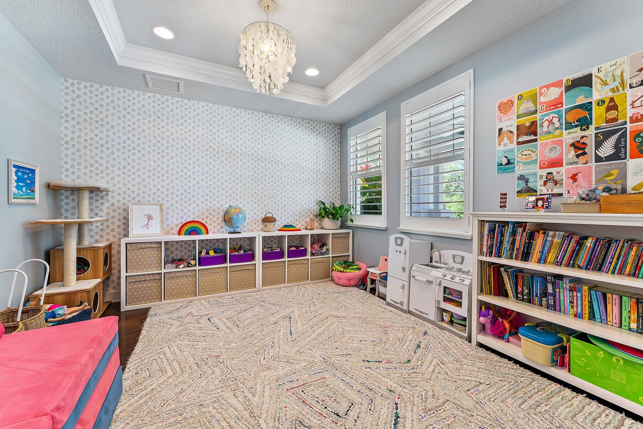 2835 East Mallory Boulevard Jupiter, FL 33458 - Photo 6 of 51 a bedroom with furniture and a book shelf