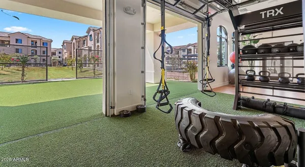 a view of a room with lots of gym equipment