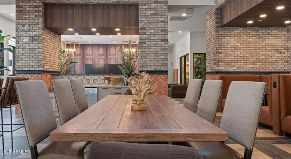 a view of a dining room with furniture and a potted plant