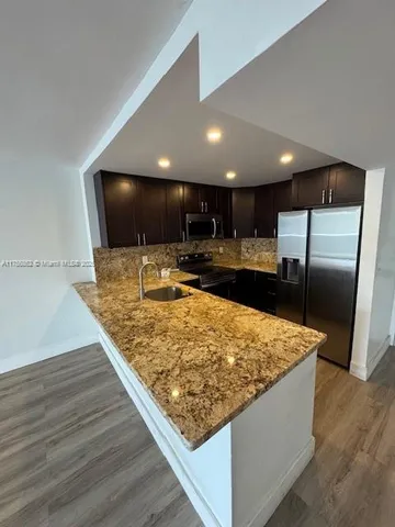 a large kitchen with a table and chairs