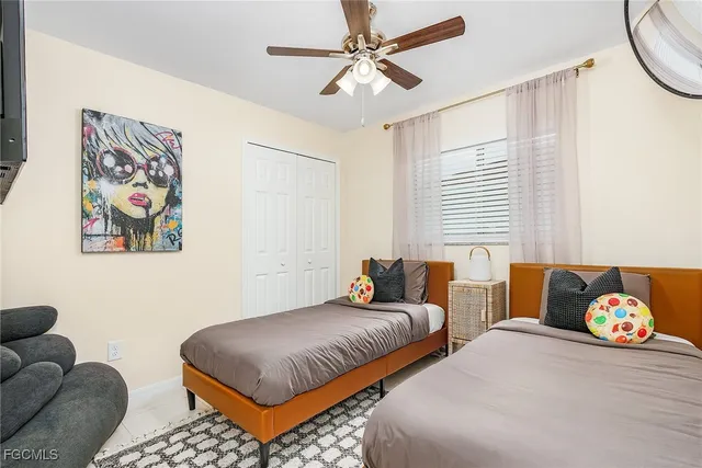 a bedroom with two beds and a couch