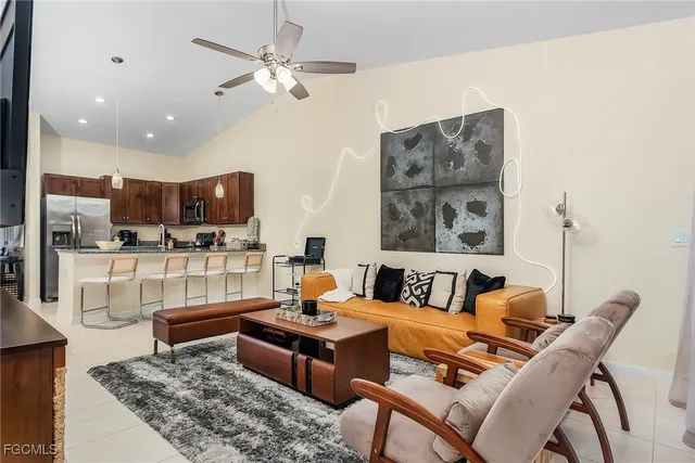 a living room with furniture and kitchen view