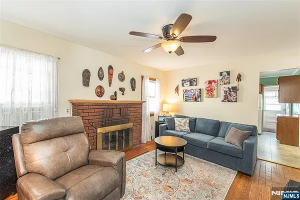 a living room with furniture a fireplace and a window