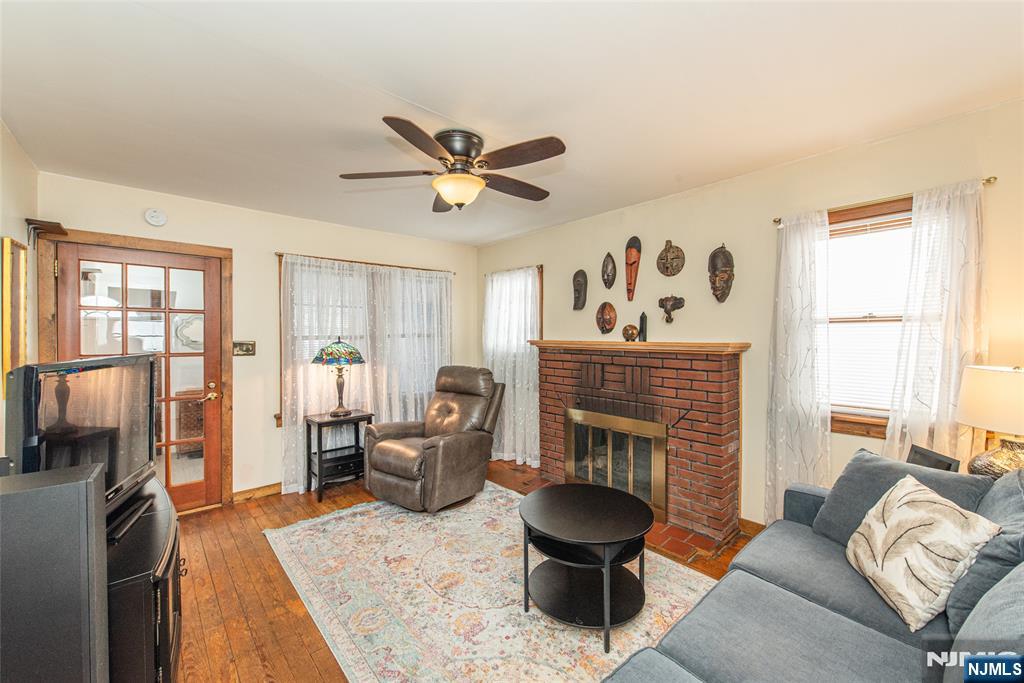 8 South Shore Road Denville, NJ 07834 - Photo 2 of 18 a living room with furniture a fireplace and a flat screen tv