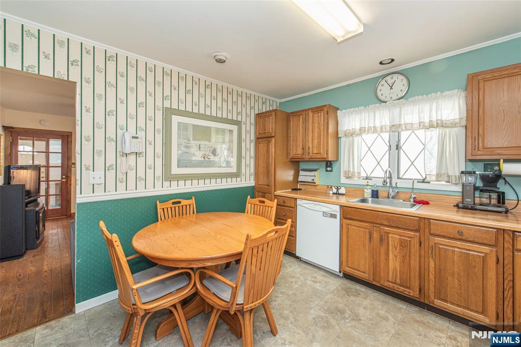 8 South Shore Road Denville, NJ 07834 - Photo 4 of 18 a kitchen with stainless steel appliances granite countertop a sink a stove a dining table and chairs
