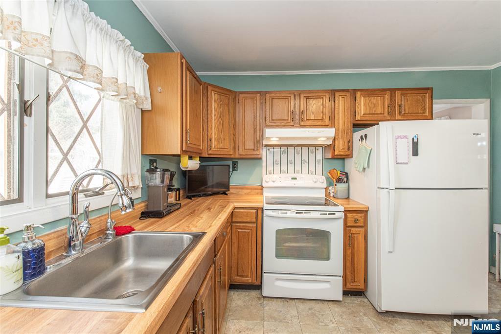 8 South Shore Road Denville, NJ 07834 - Photo 6 of 18 a kitchen with a white cabinets and white appliances