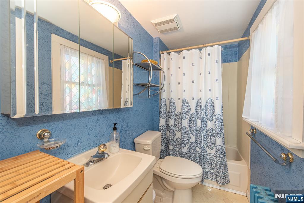 8 South Shore Road Denville, NJ 07834 - Photo 7 of 18 a bathroom with a sink toilet and shower