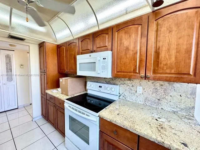 a kitchen with a stove a sink and a refrigerator