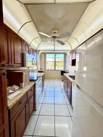 a large kitchen with stainless steel appliances granite countertop a stove and cabinets