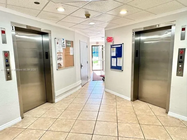 a view of a patio with table and chairs next to a yard