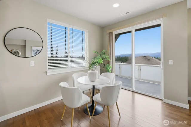 a living room with furniture kitchen and a table