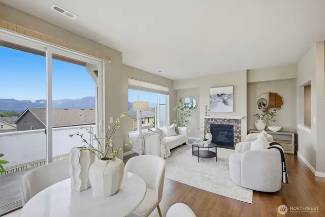 a living room with furniture a fireplace and a potted plant