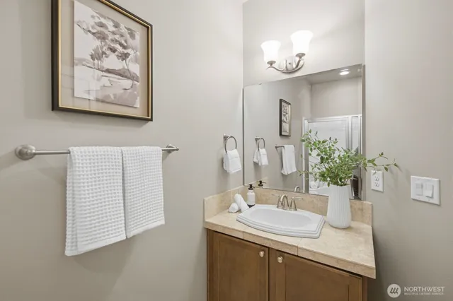 a bathroom with a glass shower door and a window