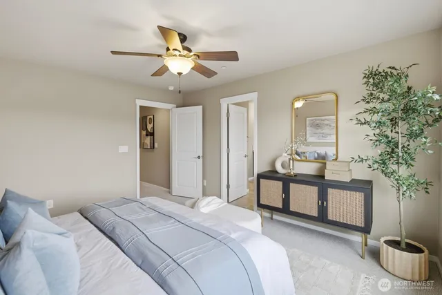 a living room with a bed furniture and a large window