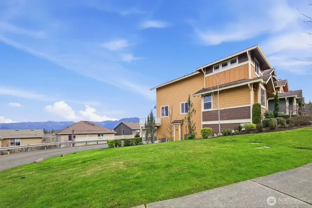 a backyard of a house with table and chairs