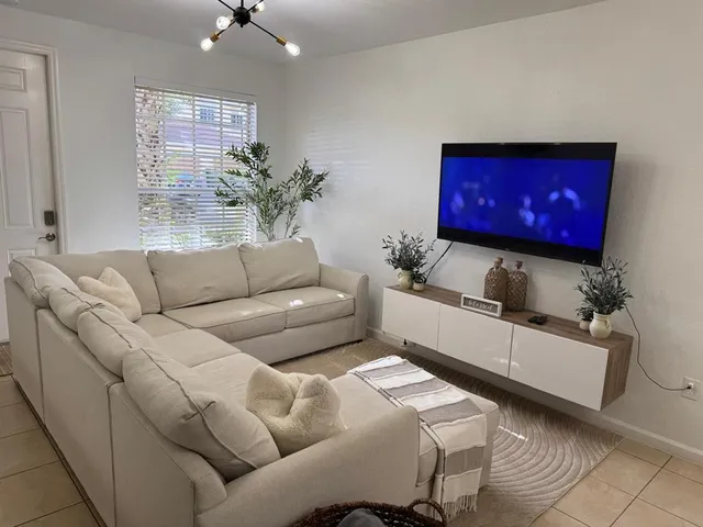 a living room with furniture and a potted plant