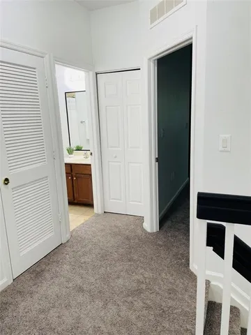 an entryway with a cabinet and a front door