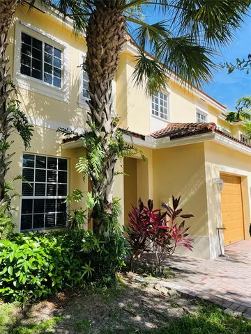 a view of a house with a flower garden
