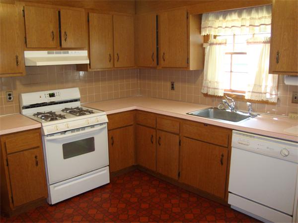 10 Winslow Road Chelmsford, MA 01824 - Photo 8 of 16 a kitchen with a sink stove top oven and cabinets