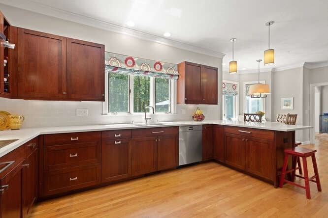 51 Fox Run Road Sudbury, MA 01776 - Photo 12 of 37 a kitchen with stainless steel appliances granite countertop a sink dishwasher a stove and a refrigerator with wooden cabinets