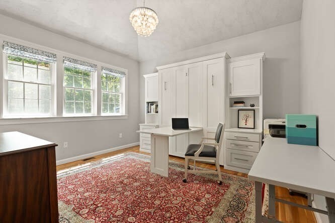 51 Fox Run Road Sudbury, MA 01776 - Photo 17 of 37 a living room with furniture a flat screen tv and a window