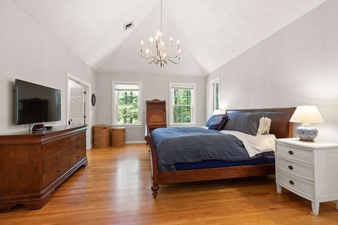 51 Fox Run Road Sudbury, MA 01776 - Photo 18 of 37 a spacious bedroom with a bed and a flat screen tv