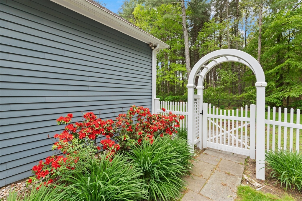 51 Fox Run Road Sudbury, MA 01776 - Photo 36 of 37 a front view of a house with a flower garden