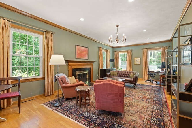 51 Fox Run Road Sudbury, MA 01776 - Photo 5 of 37 a living room with furniture a fireplace and large windows