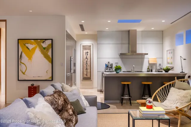 a living room with furniture and a painting