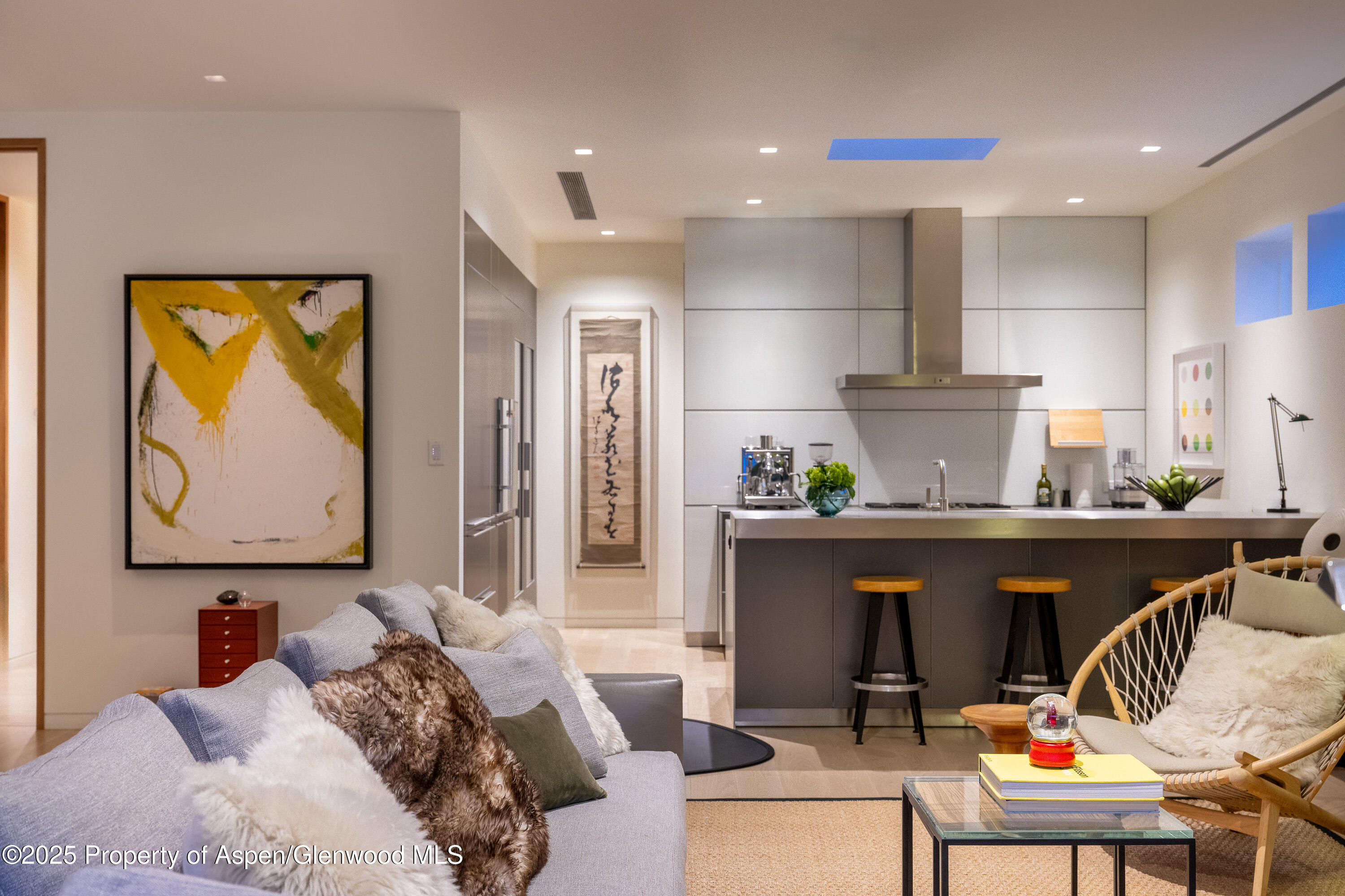 100 East Cooper Avenue, Unit 11 Aspen, CO 81611 - Photo 11 of 44 a living room with furniture and a painting