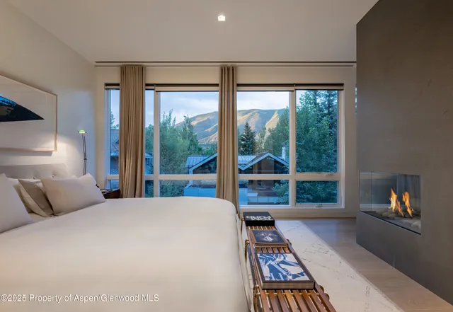 a bedroom with a large bed and a large window