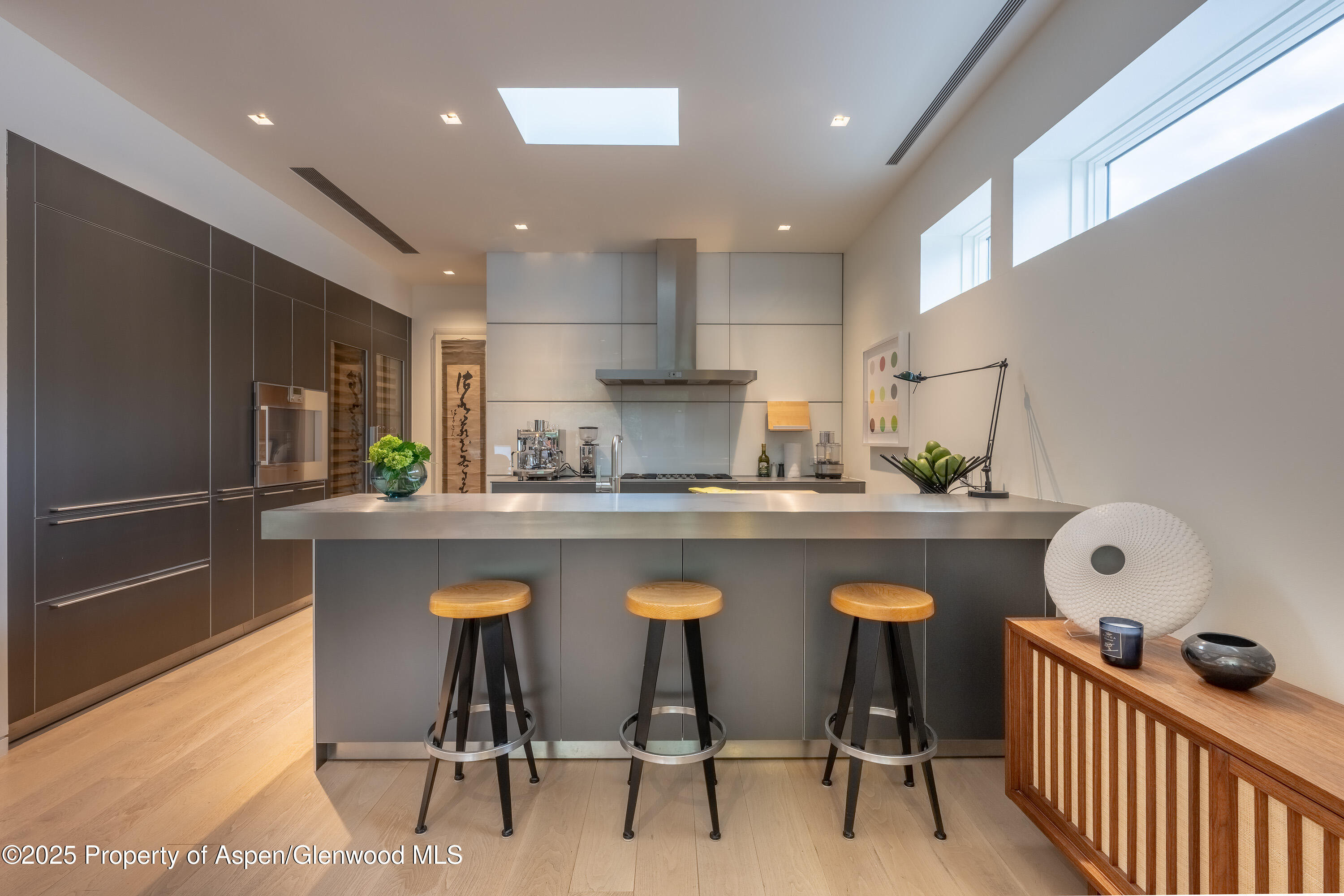 100 East Cooper Avenue, Unit 11 Aspen, CO 81611 - Photo 21 of 44 a kitchen with white cabinets and stainless steel appliances