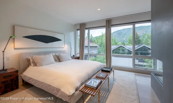 a bedroom with a large bed and a large window